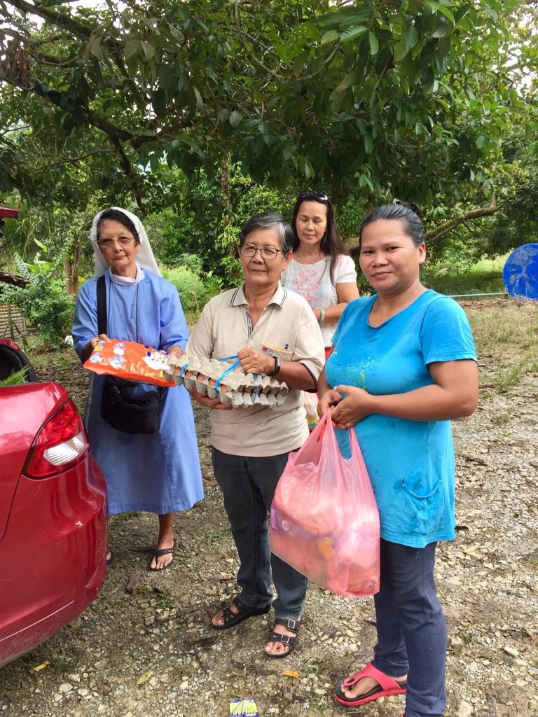 Sr Stella providing food to village members