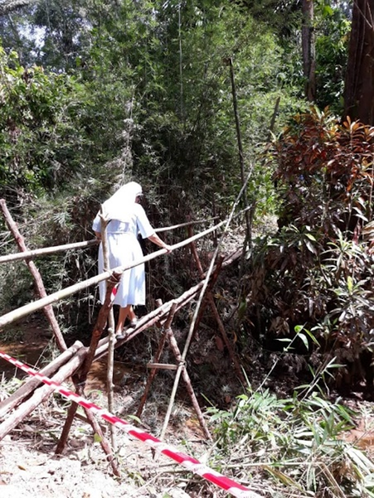 Sr Stella traveling through the jungle to serve